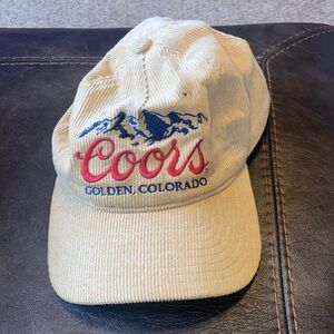 Coors Courdoroy tan adjustable baseball cap with red and navy blue embroidery.